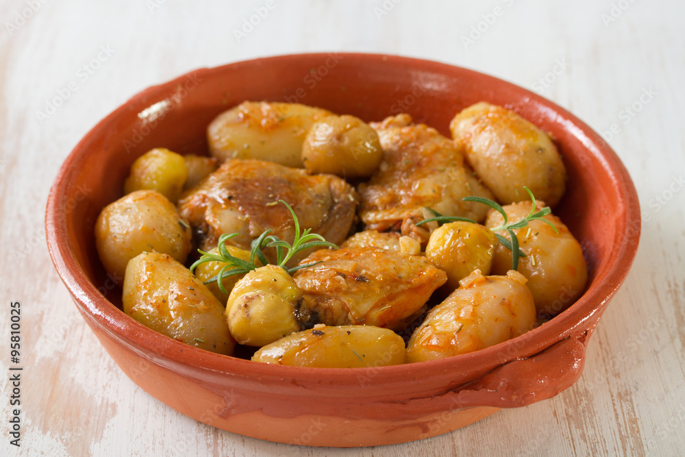 chicken with potato and chestnuts on ceramic dish chicken with potato and chestnuts on ceramic dish