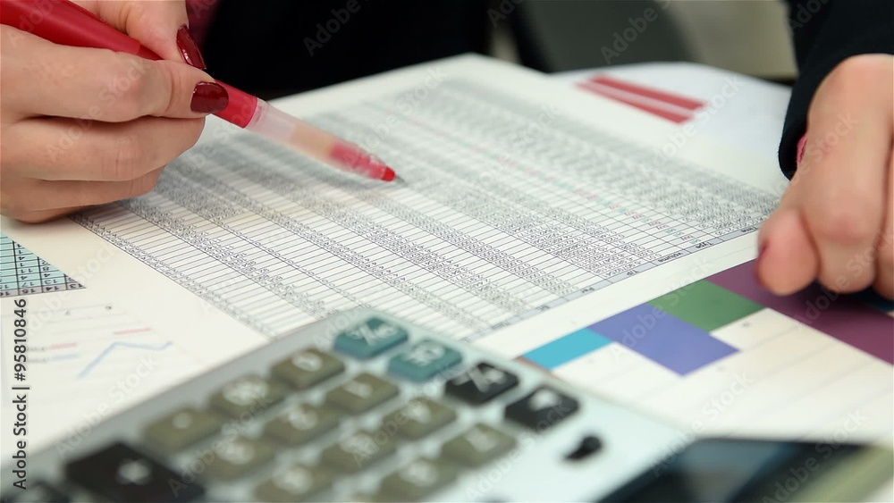 woman trader checking budget and drawing maximum value woman trader checking budget and drawing maximum value