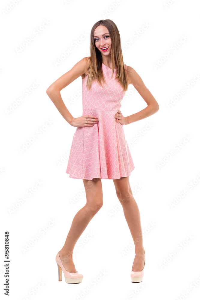 Full length of sensual woman in short dress dancing against isolated white