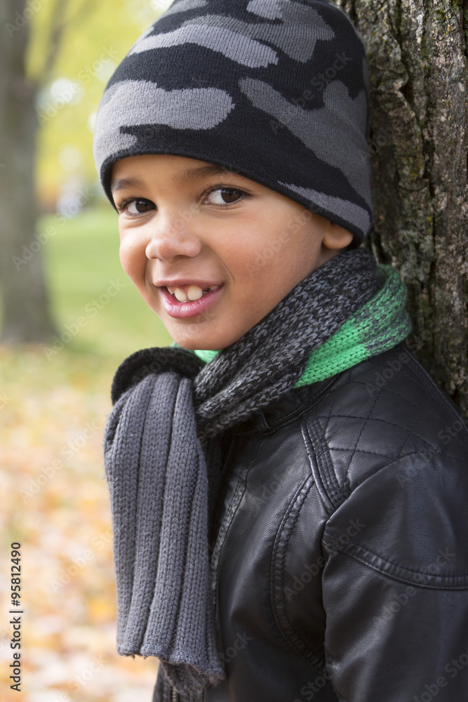 cute boy with autumn leaves in the park cute boy with autumn leaves in the park