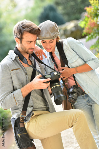 Team of young photographers doing a photo reportage