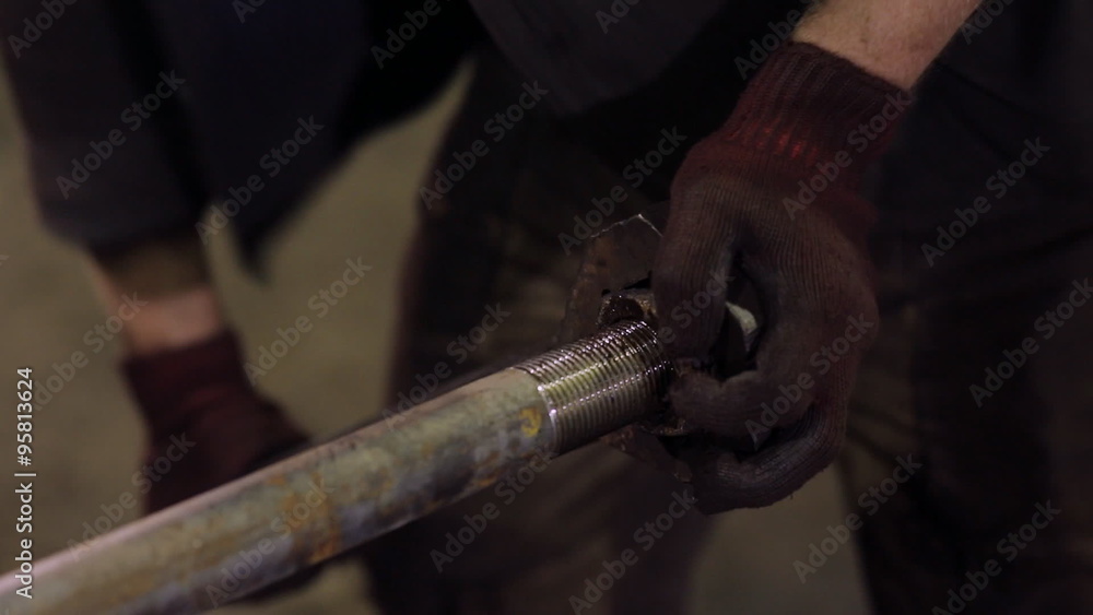 factory worker with a wrench to tighten the screws factory worker with a wrench to tighten the screws