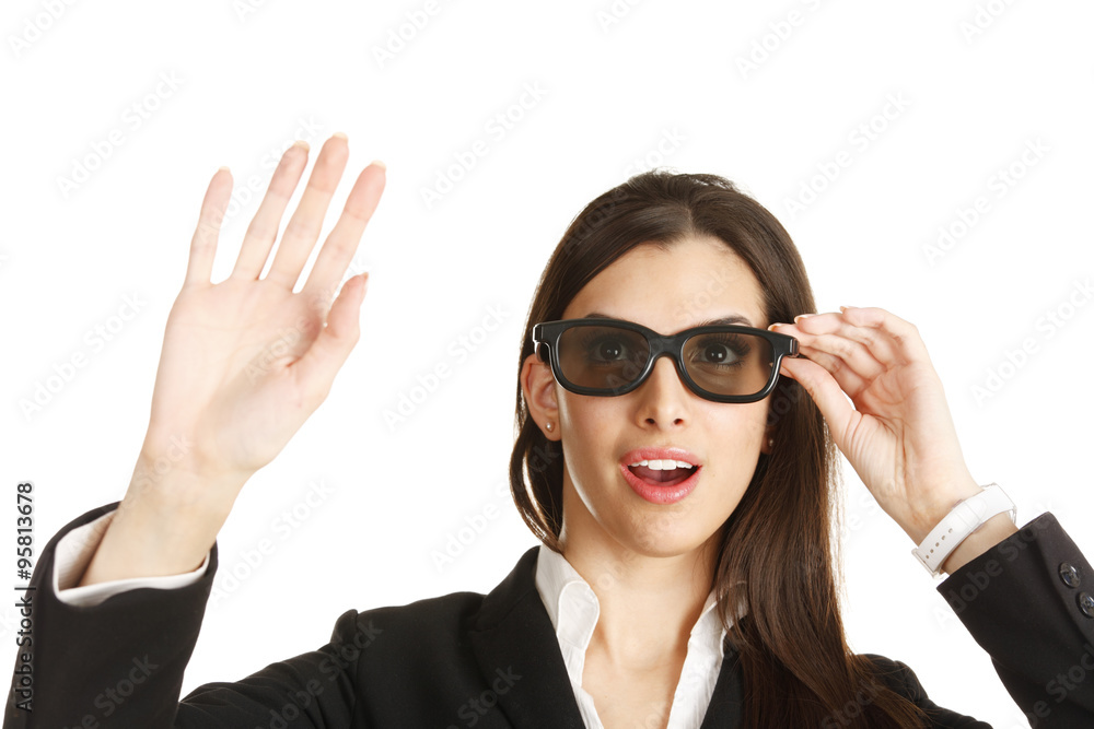 An amazed young woman reaches with her hand while looking through her 3D glasses. An amazed young woman reaches with her hand while looking through her 3D glasses.