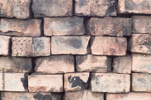 Old dry masonry wall of burnt bricks closeup