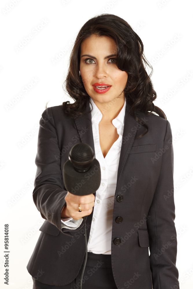 A young woman holds out her microphone to viewer. Focus is on the woman. A young woman holds out her microphone to viewer. Focus is on the woman.