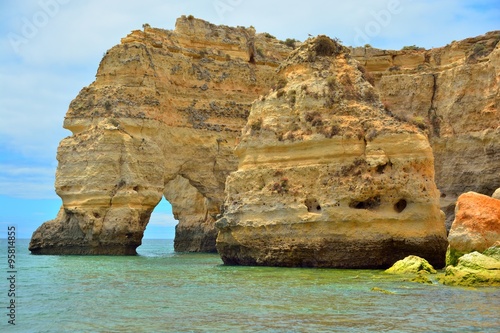 Atlantic ocean coast in the Algarve, azure ocean water and huge rocks and cliffs