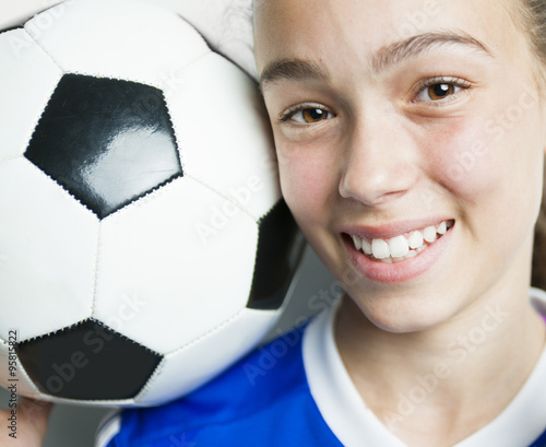 girl in sport wear with football isolated on white background photo