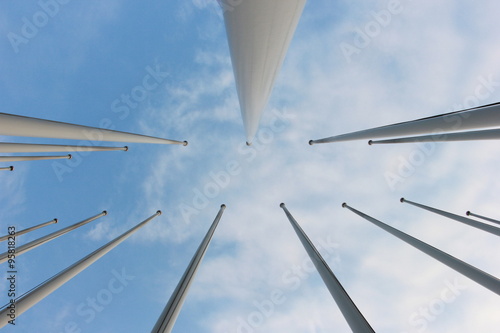 group of flagpoles and sky background