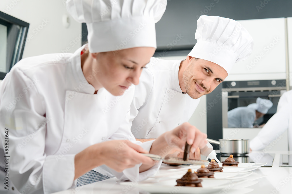portrait of a handsome young man professional pastry cook preparing a chocolate dessert portrait of a handsome young man professional pastry cook preparing a chocolate dessert