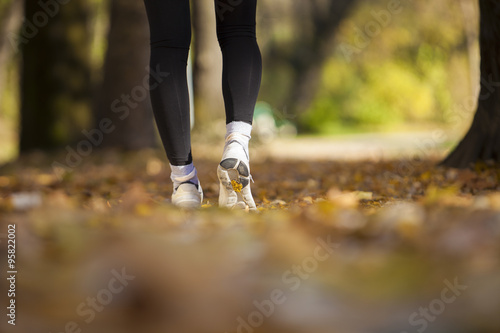 Pretty young girl exercise in the park, shallow depth of field