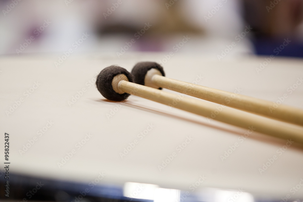 Drumsticks lying on timpani closeup Drumsticks lying on timpani closeup