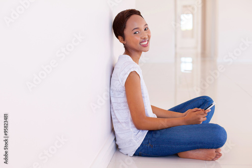 Free Download young african woman holding smart phone - GFXLoad