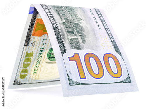 Native dollar folded in half, money hut, currency angle isolated