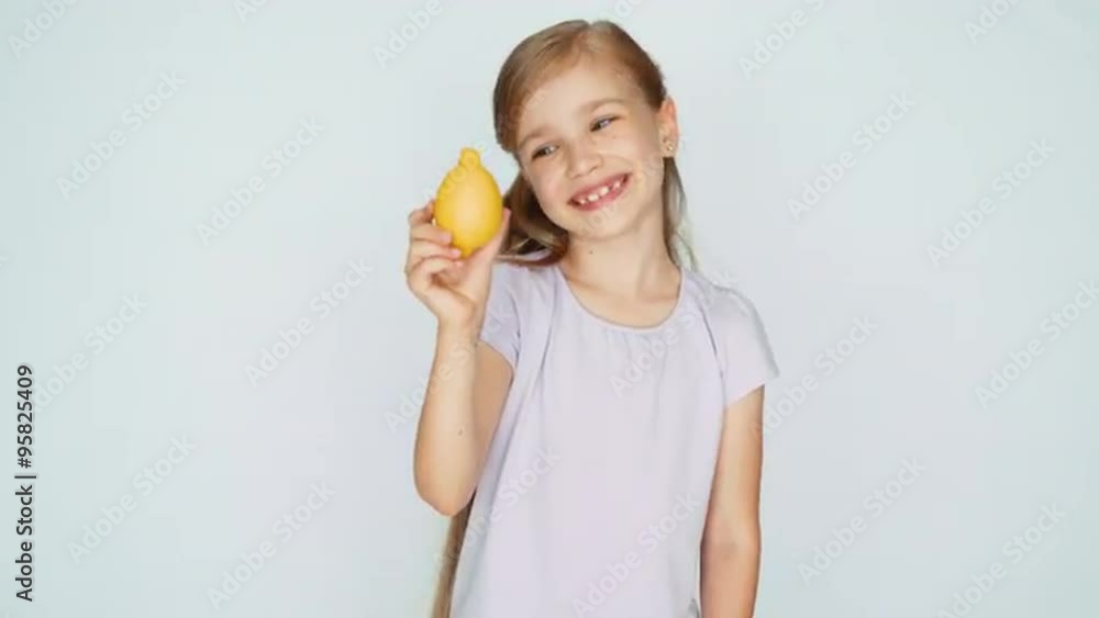 Girl considering a lemon. Thumb up. Ok. Girl laughing at camera Girl considering a lemon. Thumb up. Ok. Girl laughing at camera