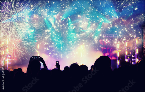 New Year concept - cheering crowd and fireworks © erika8213