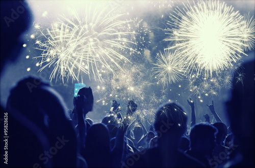 New Year concept - cheering crowd and fireworks