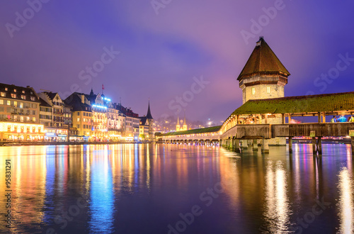 Lucerne, Switzerland, night view over the Reuss river to the wooden Chapel bridge