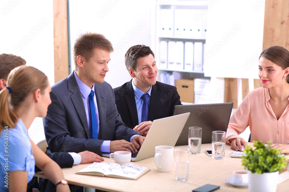 Business meeting - manager discussing work with his colleagues Business meeting - manager discussing work with his colleagues