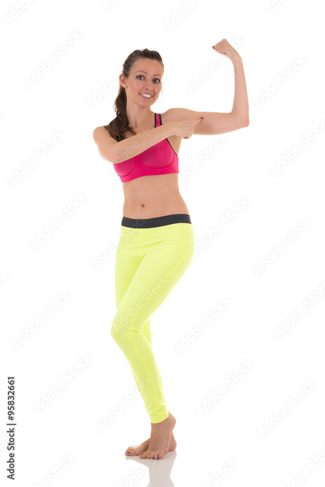 Sexy happy brunette woman shows biceps muscles. Sexy happy brunette woman shows biceps muscles.