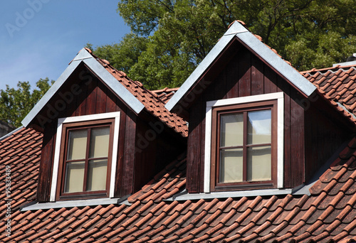 Konstfotografi orange tiled roof and garret windows in old house