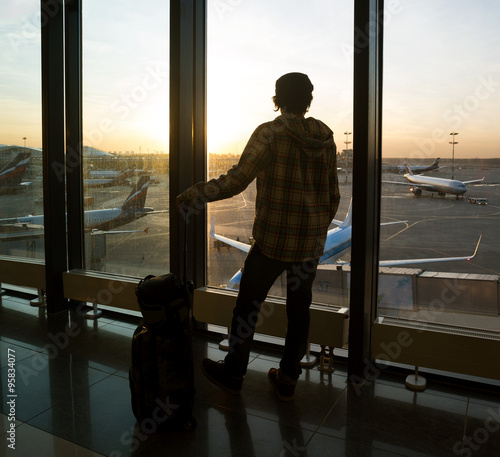 Silhouette of man near window in airport © maxoidos