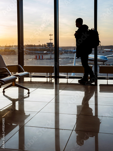 Silhouette of man near window in airport