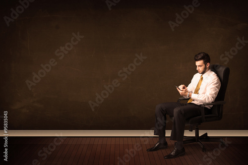 Businessman holding high tech tablet on background with copyspac