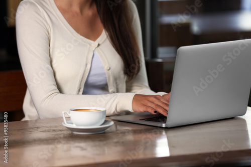 Young woman working with laptop in the office