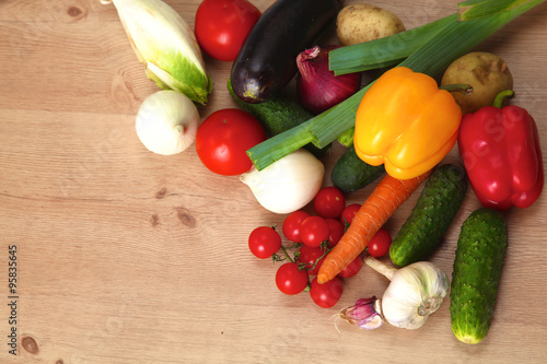 Pile of organic vegetables on a wooden table