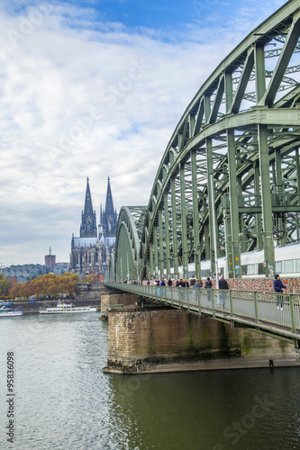 Cathedral of Cologne with iron arcs of Hohenzollern bridge, Colo © travelview
