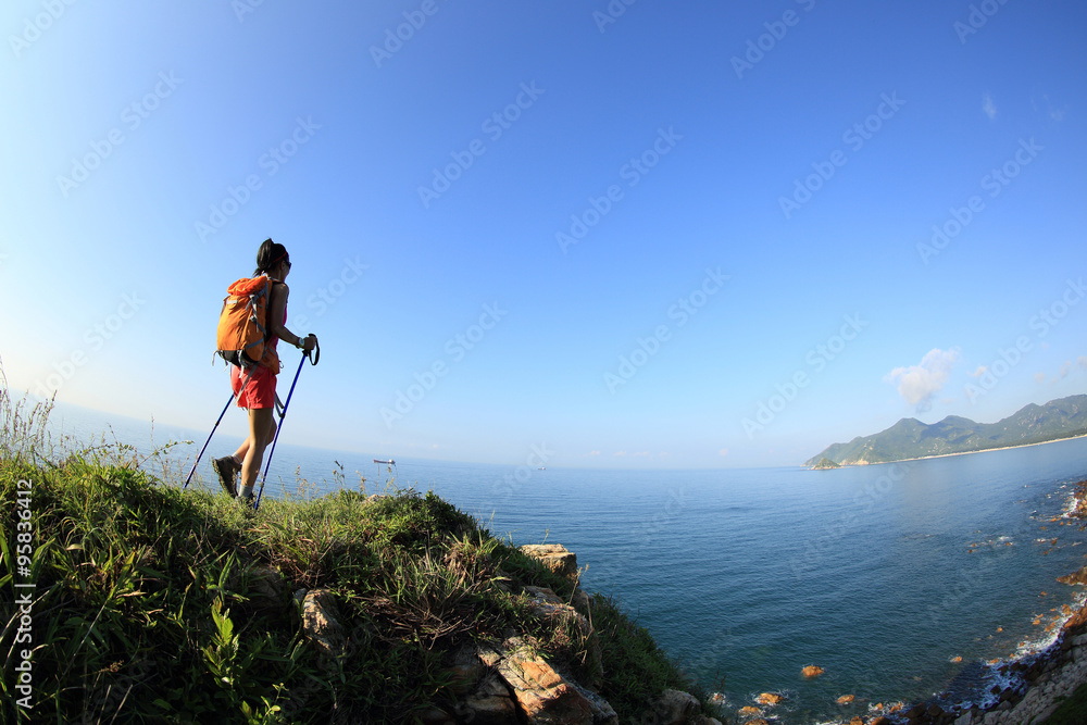 woman hiker legs hiking on seaside mountain trail