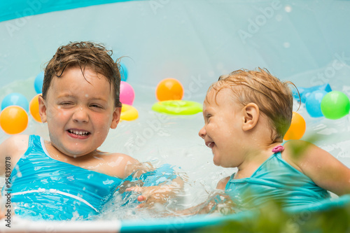 Children swimming in kid pool photo