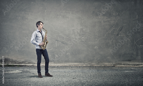 Handsome saxophonist. Concept image © Sergey Nivens