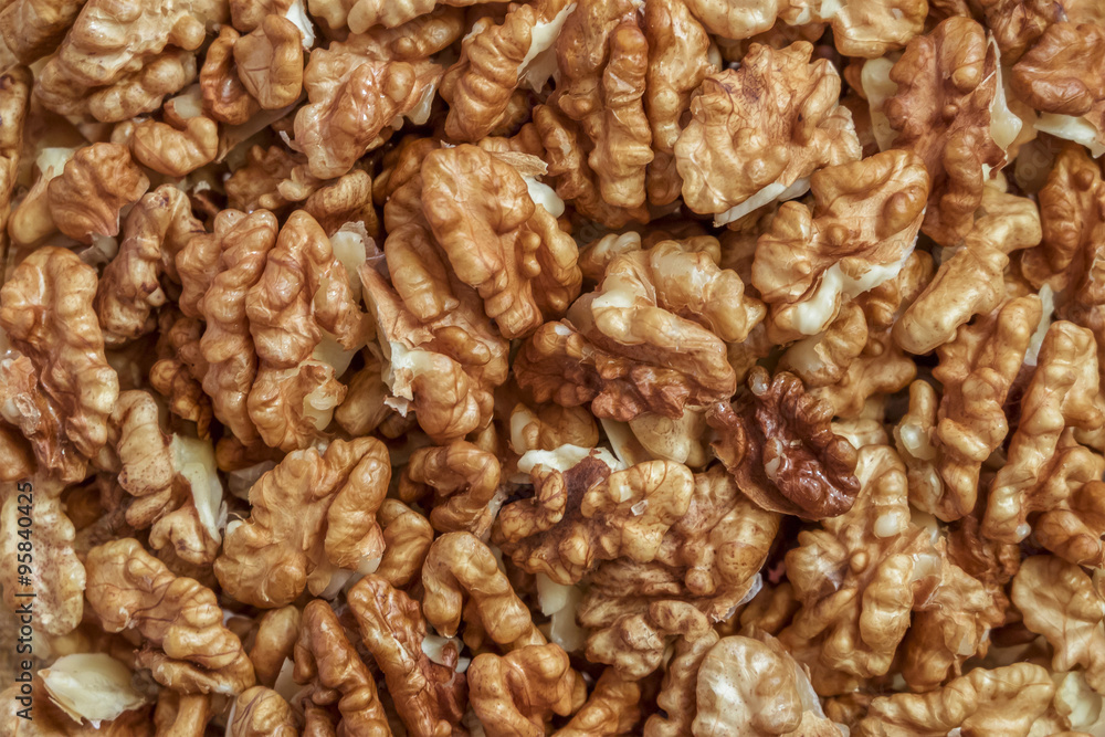 Walnuts. Background of peeled bright walnut kernels. Walnuts. Background of peeled bright walnut kernels.