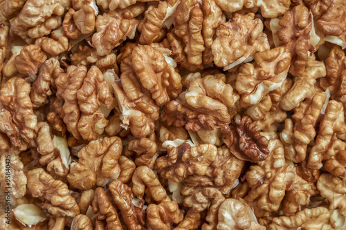 Walnuts. Background of peeled bright walnut kernels.