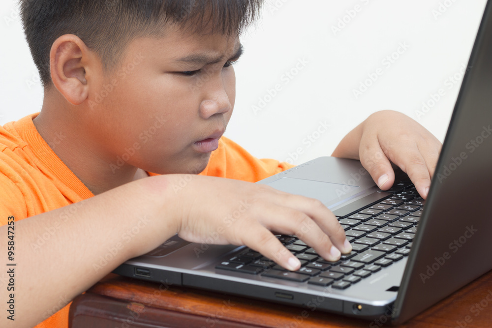 Portrait of lovely children looking at computer monitor while typing, serious Portrait of lovely children looking at computer monitor while typing, serious