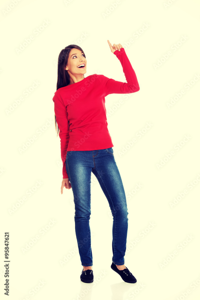 Smiling woman pointing up. Smiling woman pointing up.