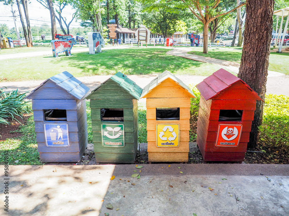 Old wooden bins , blue, green , yellow, red , marked with recycl