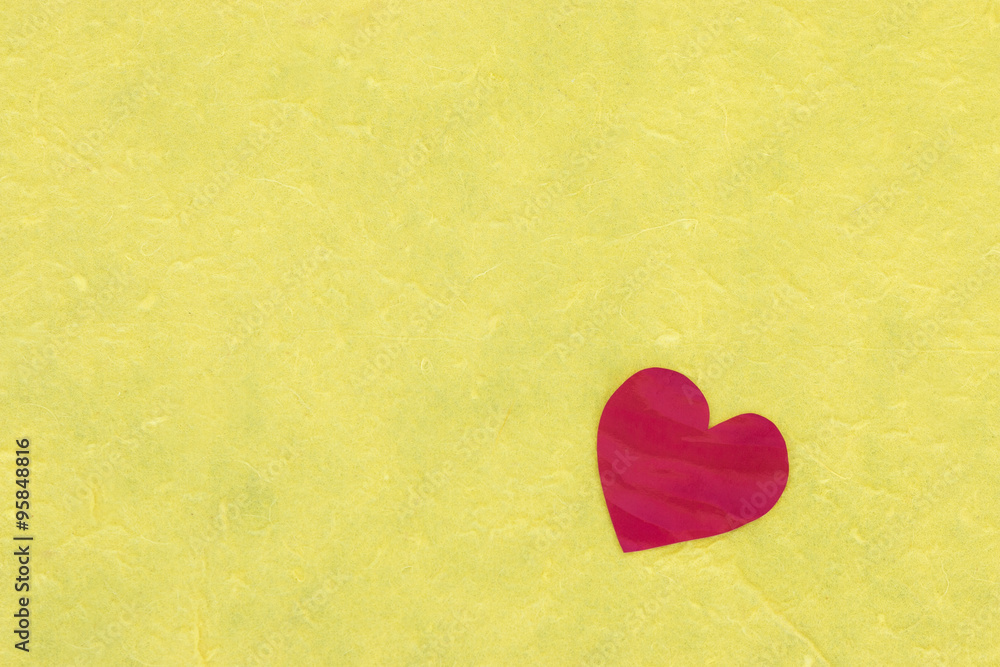 Red heart on yellow paper background, love concept Red heart on yellow paper background, love concept