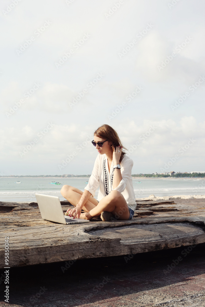 Outdoor portrait of young writer/blogger/freelancer/student with laptop
