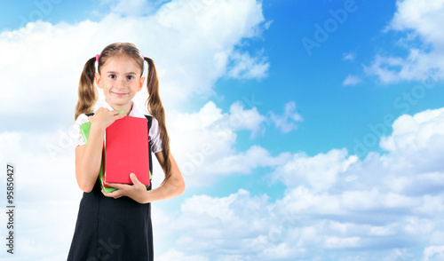 Schoolgirl on blue sky background © Africa Studio