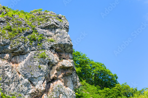 Natural rock in the shape of a human head allocated to the mountain range. Far East, Russia.