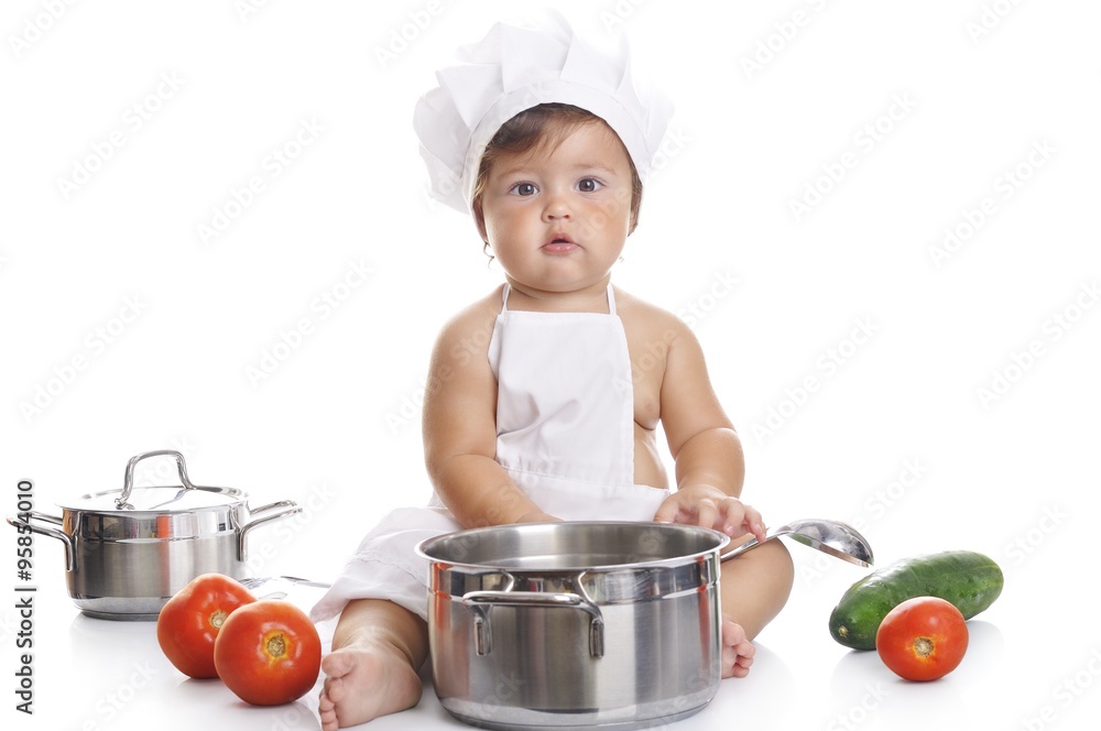 Funny adorable baby boy chef sitting and playing with kitchen equipment Funny adorable baby boy chef sitting and playing with kitchen equipment