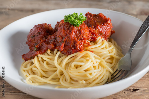 Spaghetti and Meatballs in white plate.