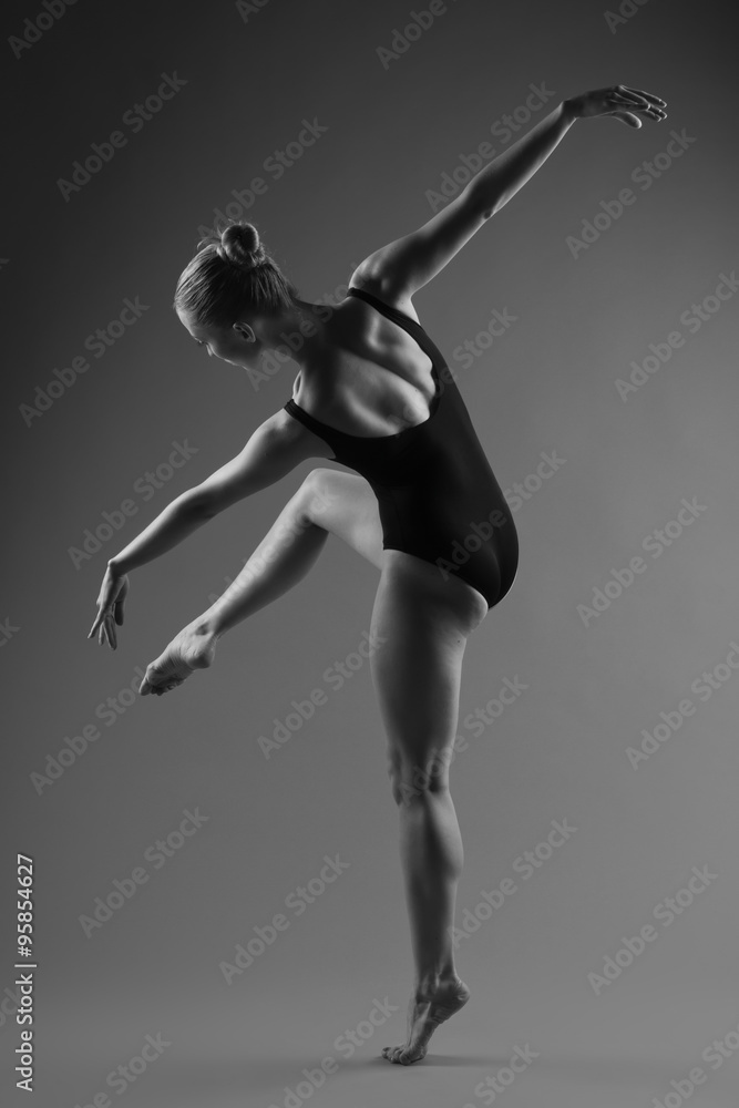 Fototapeta premium Modern ballet dancer posing on dark background