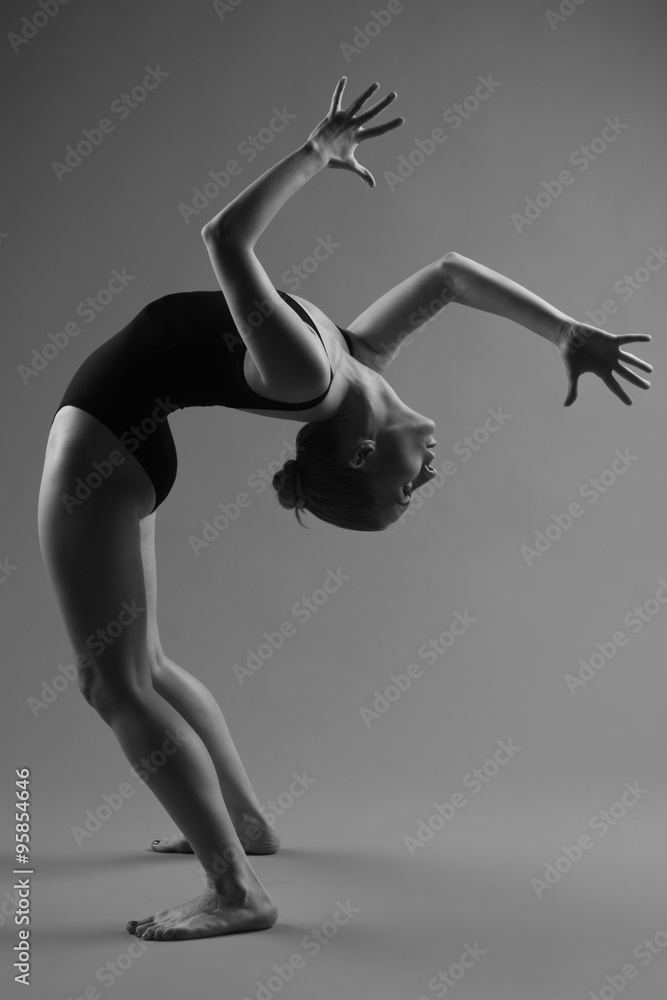 Naklejka premium Modern ballet dancer posing on dark background