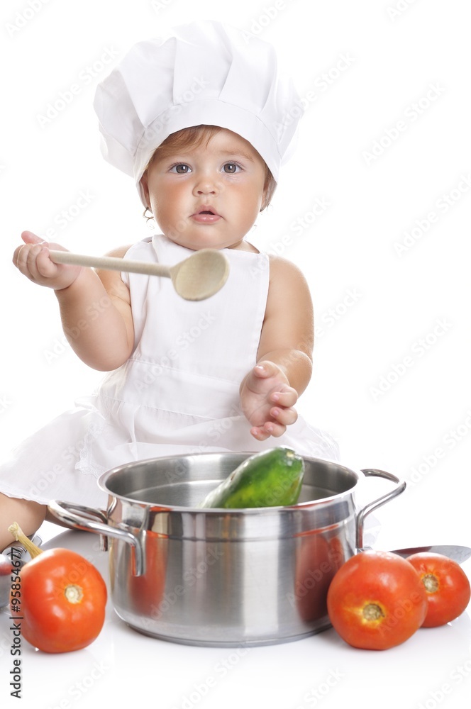 Funny adorable baby boy chef sitting and playing with kitchen equipment Funny adorable baby boy chef sitting and playing with kitchen equipment