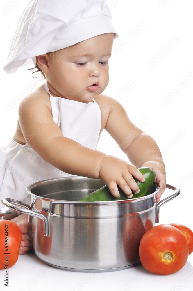 Funny adorable baby boy chef sitting and playing with kitchen equipment Funny adorable baby boy chef sitting and playing with kitchen equipment