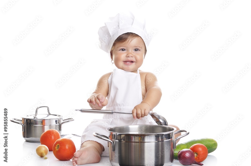 Funny adorable baby boy chef sitting and playing with kitchen equipment Funny adorable baby boy chef sitting and playing with kitchen equipment