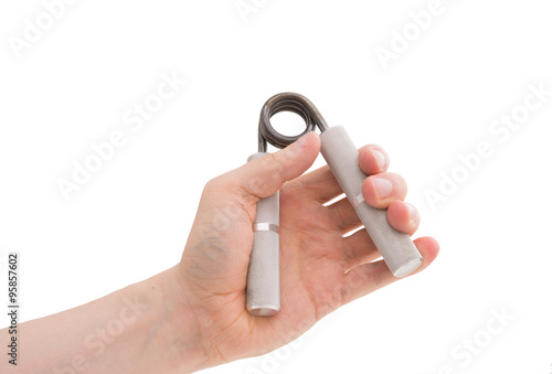 Vászonkép Male hand exercising grip strength using a metal hand gripper